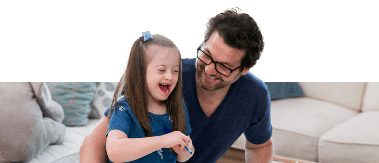 Dad playing with daughter affected by Dawn syndrome