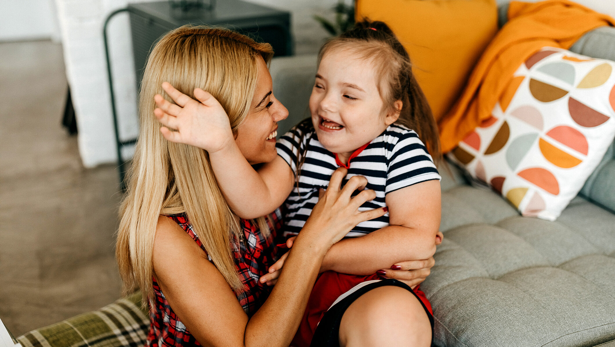 Mother helping daughter with multisystem needs