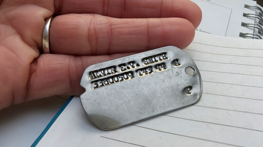 Tracy T. holding Alvin's military dog tag