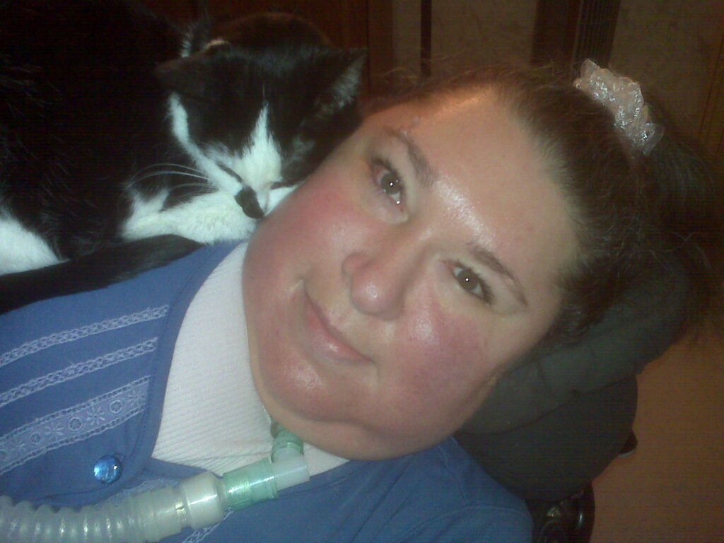 photo of Maria laying down with her black and white cat