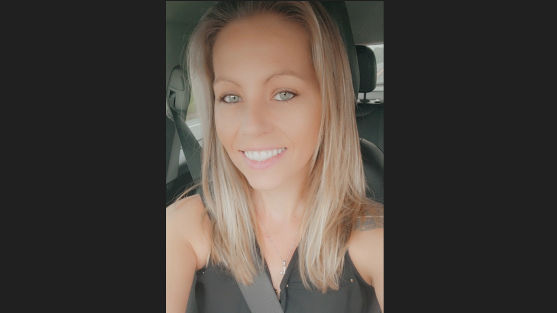 female PPL employee smiling sitting in her car