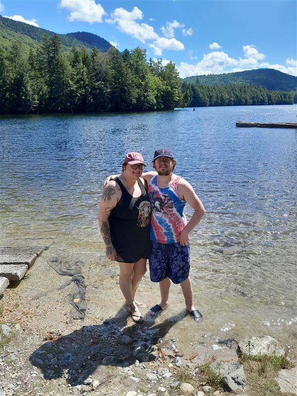 Female PPL employee standing with a man in front of a lake